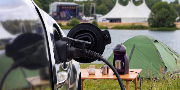 Voldt® portable charging cable powering an electric car at a lakeside summer campsite