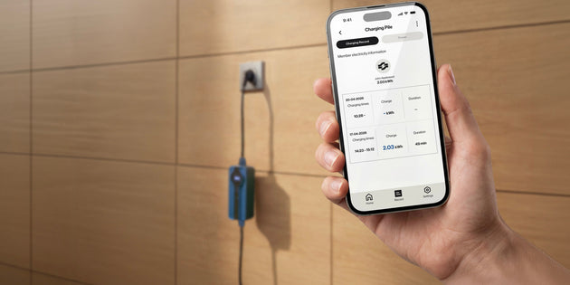 Voldt® smart charging app on a smartphone next to a wall-mounted portable charger