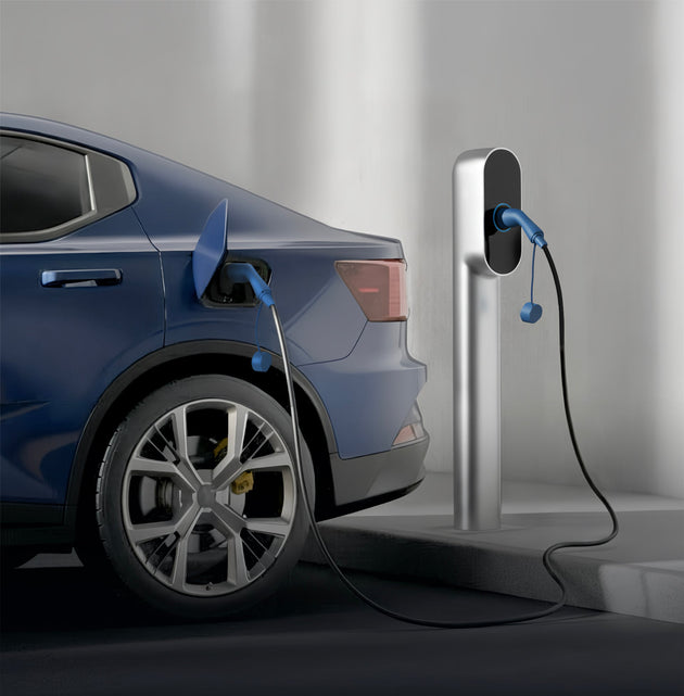 Side view of a blue electric car plugged into a silver charging pedestal indoors